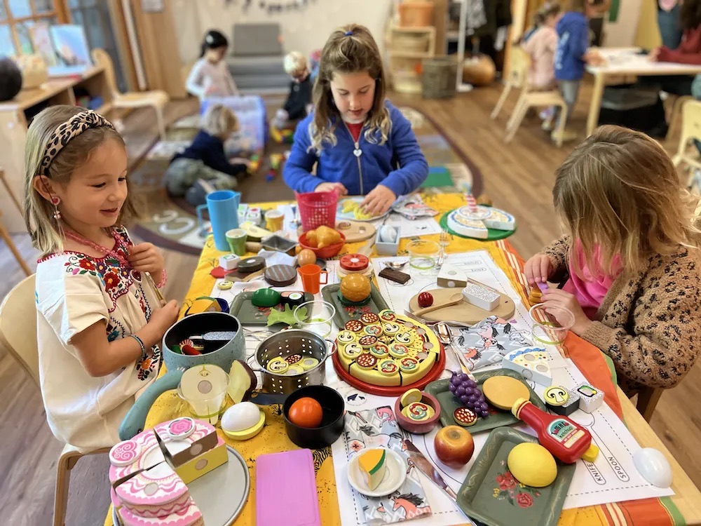 Children playing in the kitchen at The Ross Preschool